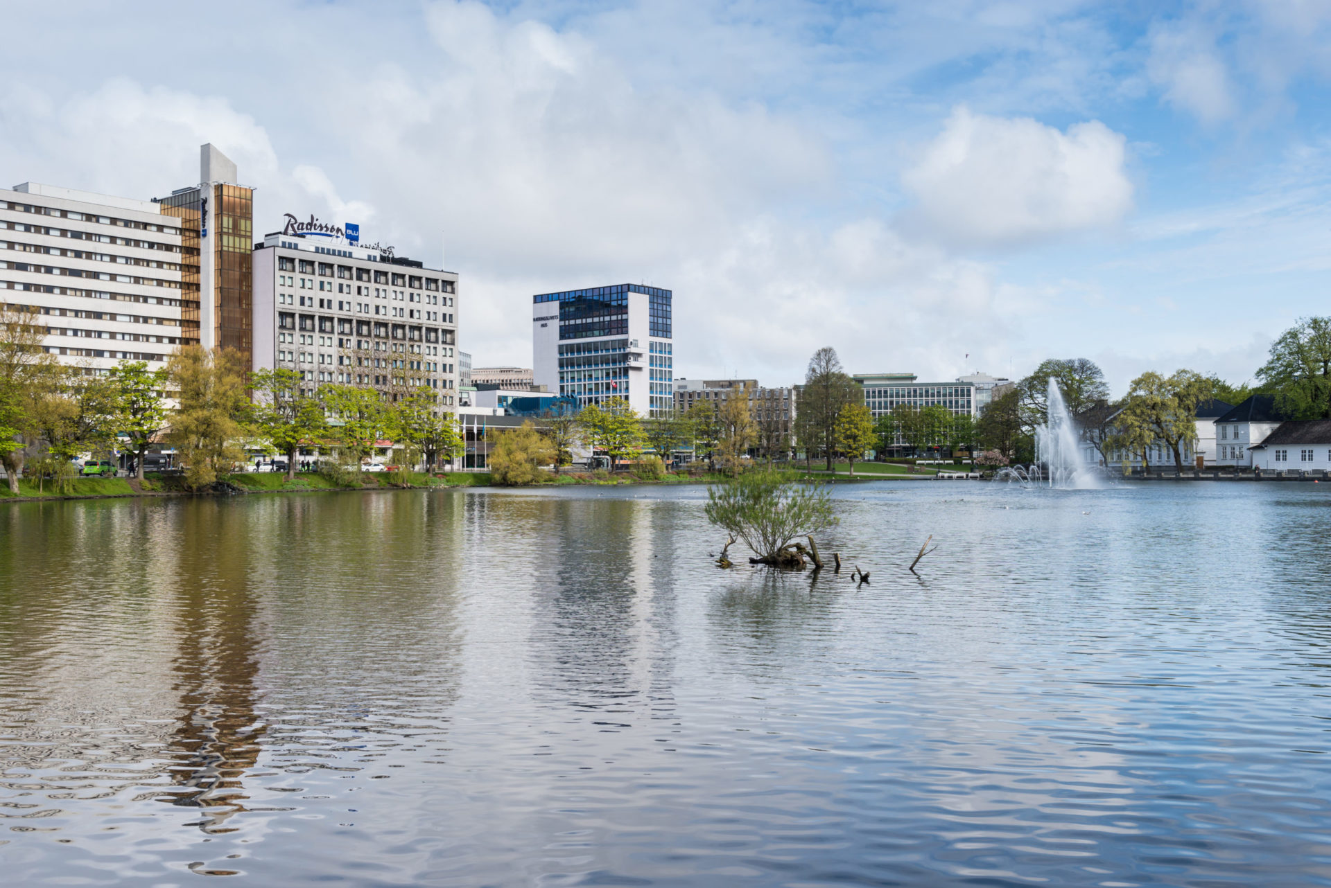 Stavanger, Norway - May 27, 2015: View of the Breiavatnet lake and the water fountain along with commercial buildings and a hotel in the city center of Stavanger, Norway