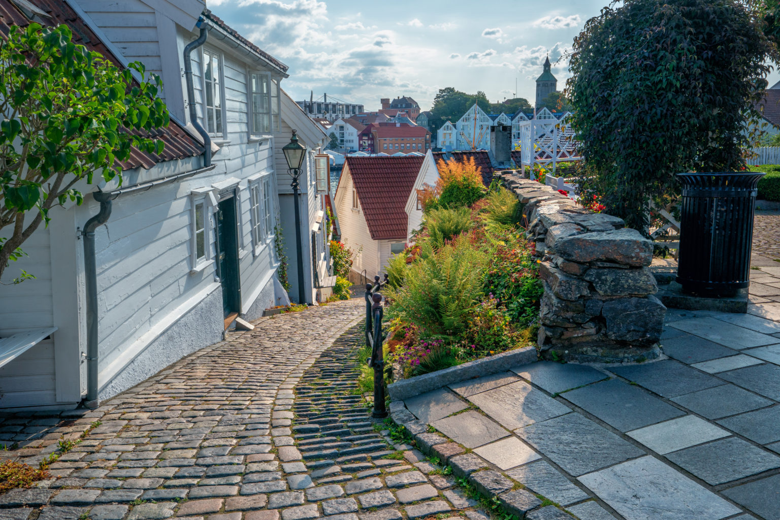 Street with Traditional white wooden houses in Gamle Stavanger on Sunny day.  Norway