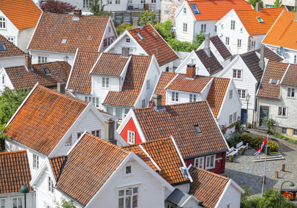 9th August, 2019 - Arial view of some houses in the Norwegian town of Stavanger with its sprinkling of white wooden houses topped with red slate roofs